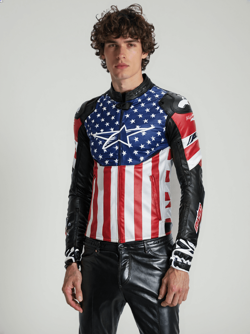 Detail shot of a leather biker jacket with American flag design and bold logo, emphasizing the stylish and functional features.
