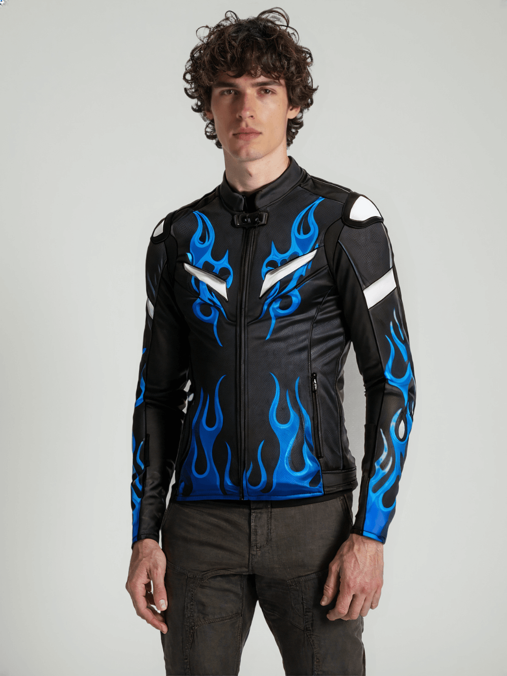 Close-up of a black leather motorcycle jacket showcasing intricate blue flame patterns and silver reflective details.