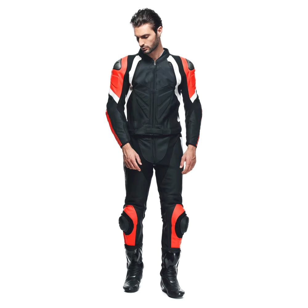 A person wearing a red, black, and white motorcycle leather suit with metal armor and a mesh lining.