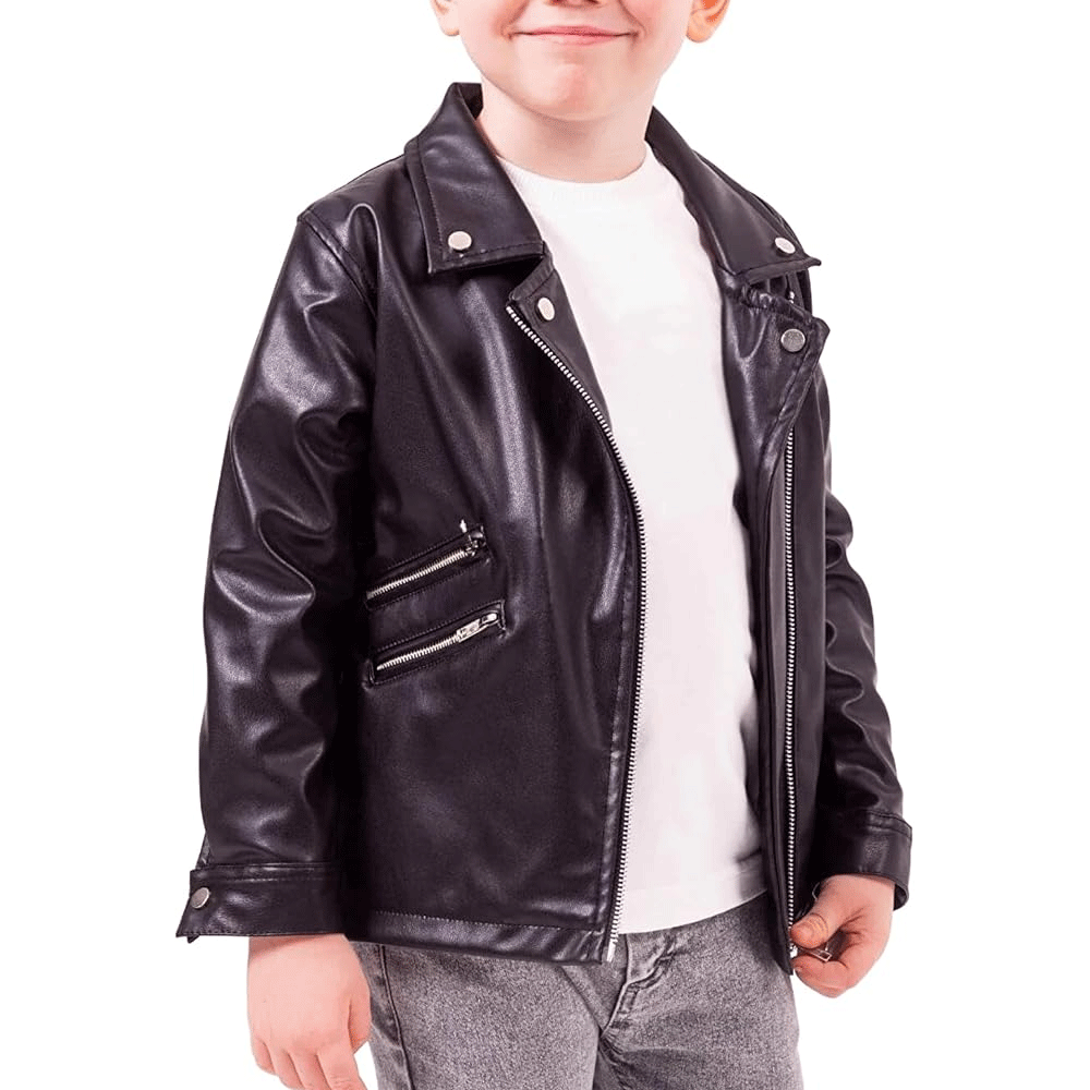 A young child wearing a black leather motorcycle jacket with a white shirt underneath. The jacket features a zipper and padding on the elbows, shoulders, and back.