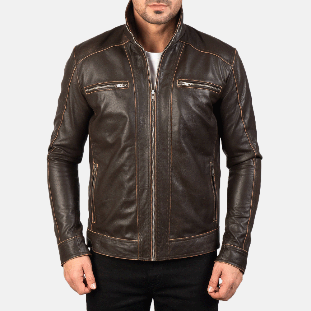 A man wearing a brown leather motorcycle jacket with embroidered leather applique graphics, a zipper front, and pockets at the elbows and shoulders.