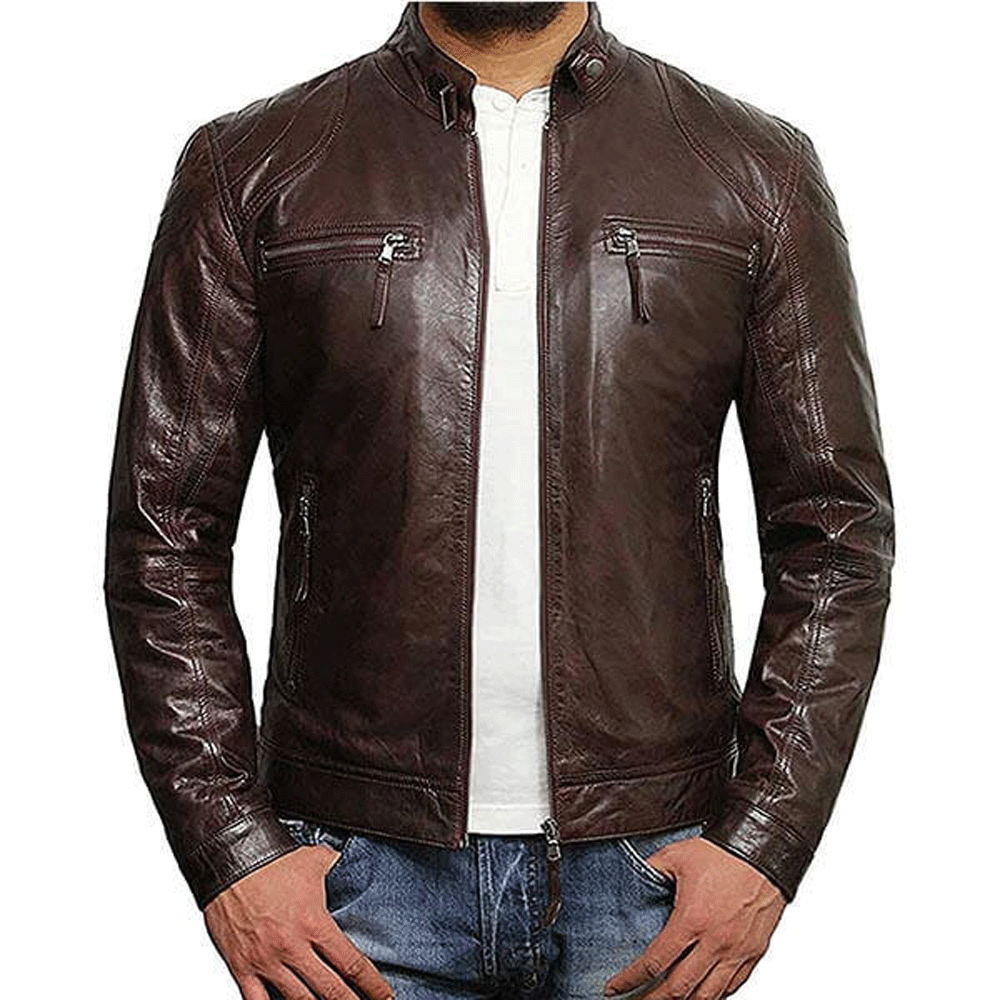 A man wearing a brown leather motorcycle jacket with a mandarin collar, embroidered leather applique graphics on the left arms, and front and back cowhide leather accents.