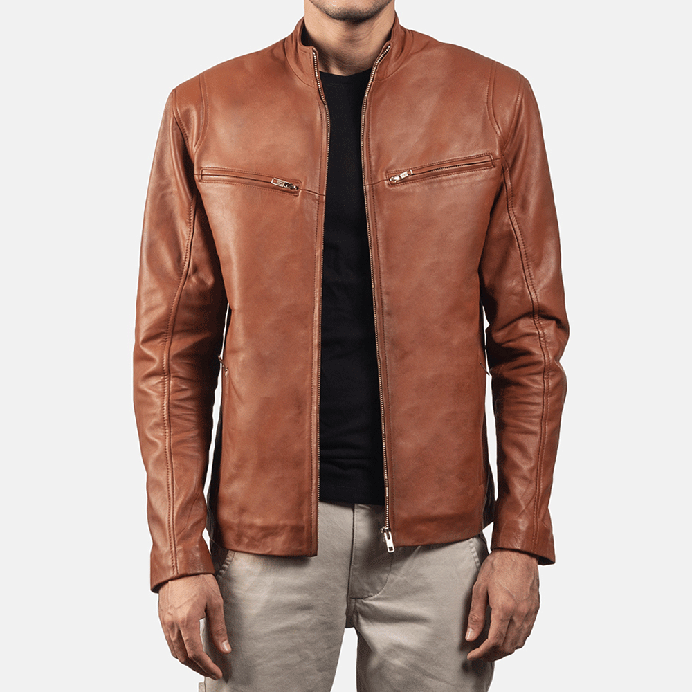 A man wearing a brown leather jacket with a mandarin collar, zipper pockets, and embroidered leather graphics on the arms and back.